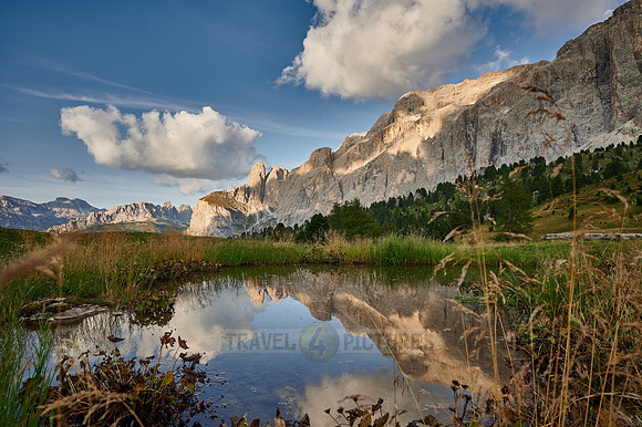 Sella group is reflected in a small lake