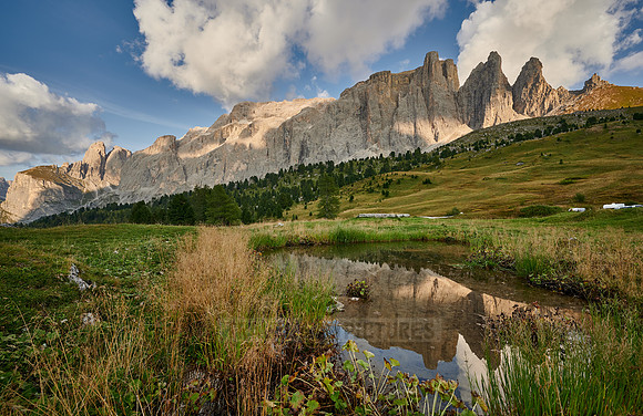 Sella group is reflected in a small lake