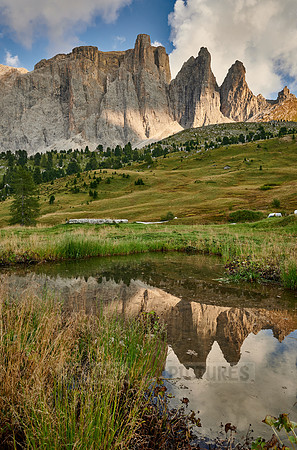 Sella group is reflected in a small lake