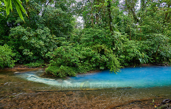 the confluence of two rivers the blue river Rio Celeste is formed