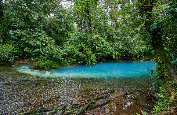 the confluence of two rivers the blue river Rio Celeste is formed