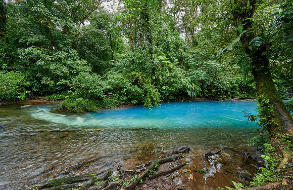 the confluence of two rivers the blue river Rio Celeste is formed