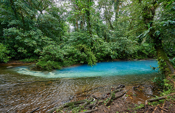 the confluence of two rivers the blue river Rio Celeste is formed