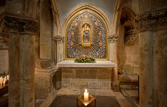 Candles beneath small altar with Mary & the baby Jesus figures inside theDom St. Peter cathedral