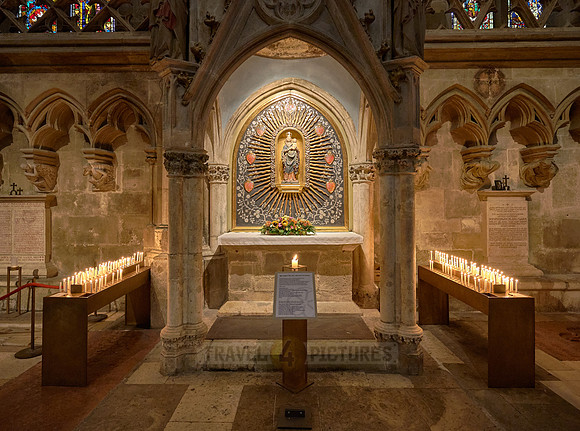 Candles beneath small altar with Mary & the baby Jesus figures inside theDom St. Peter cathedral