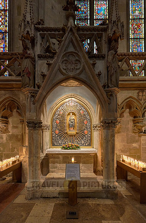 Candles beneath small altar with Mary & the baby Jesus figures inside theDom St. Peter cathedral
