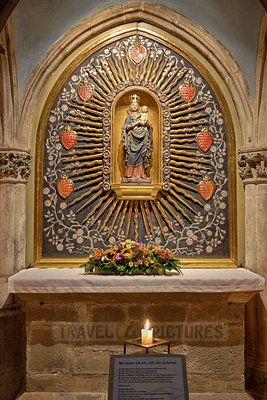 Candles beneath small altar with Mary & the baby Jesus figures inside theDom St. Peter cathedral
