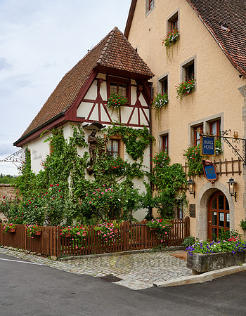 Facade of the castle hotel overgrown with plants
