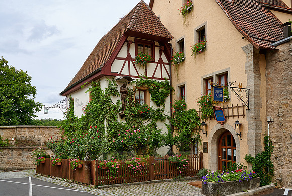 Facade of the castle hotel overgrown with plants