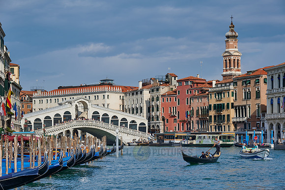 Rialto Bridge seen from boat with gondulas in front