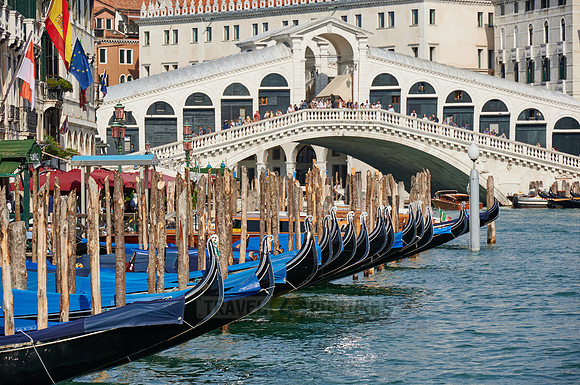 Rialto Bridge seen from boat with gondulas in front