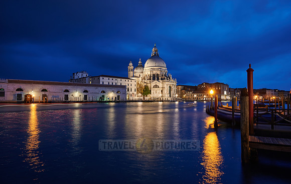 night shot of illuminated Basilica di Santa Maria della Salute with Punta della Dogana