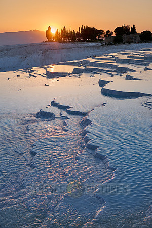 sunset behind Pamukkale travertine terraces