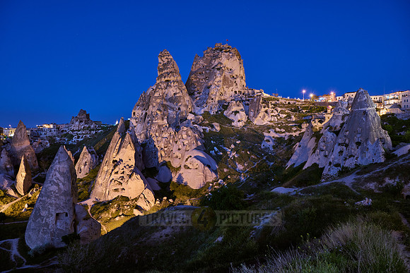 Twilight photo of the perforated castle rock of Uçhisar