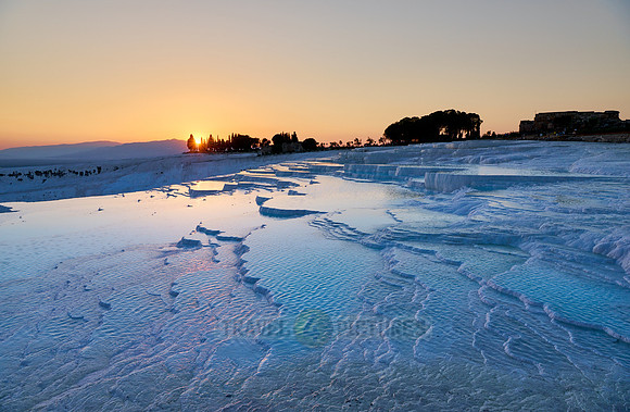 sunset behind Pamukkale travertine terraces