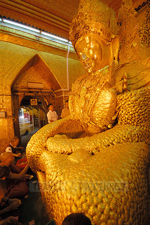uddha with thick layer of golden leaves in Mahamuni Pagoda