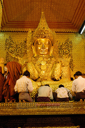 uddha with thick layer of golden leaves in Mahamuni Pagoda