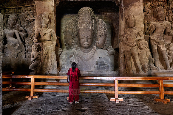 tourist in front of the Eternal Shiva, the Sadashiva, Elephanta caves