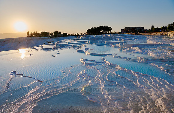 sunset behind Pamukkale travertine terraces