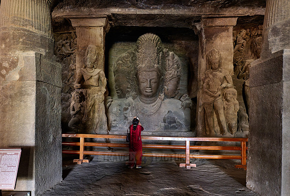 tourist in front of the Eternal Shiva, the Sadashiva, Elephanta caves