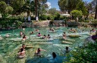 people swimming in natural swimming pool with columns in Greek Hierapolis