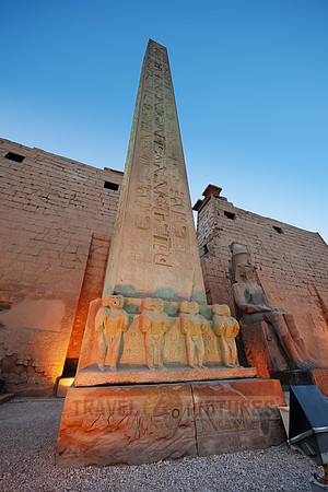 Closeup of illuminated red granite obelisk