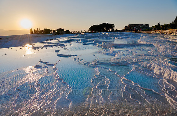 sunset behind Pamukkale travertine terraces