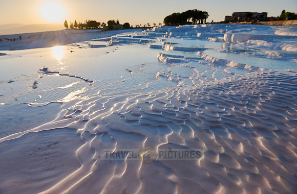 sunset behind Pamukkale travertine terraces