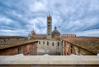 view over roofs of Siena to Cathedral of Siena