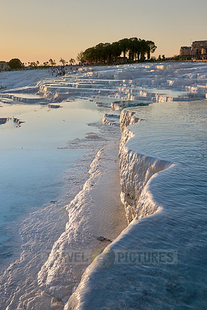 sunset behind Pamukkale travertine terraces
