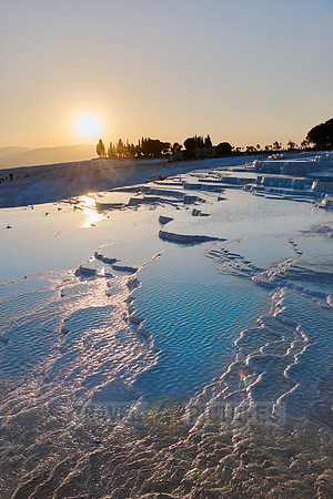 sunset behind Pamukkale travertine terraces