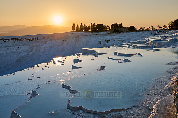 sunset behind Pamukkale travertine terraces