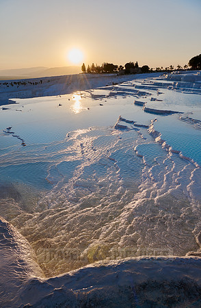 sunset behind Pamukkale travertine terraces