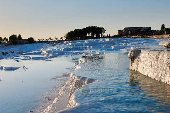 sunset behind Pamukkale travertine terraces