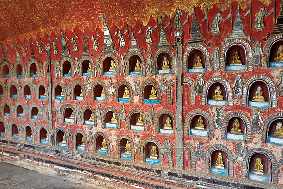many small Budda figures in niches