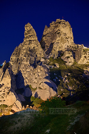 Twilight photo of the perforated castle rock of Uçhisar