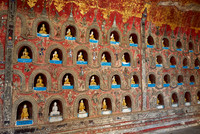 many small Budda figures in niches