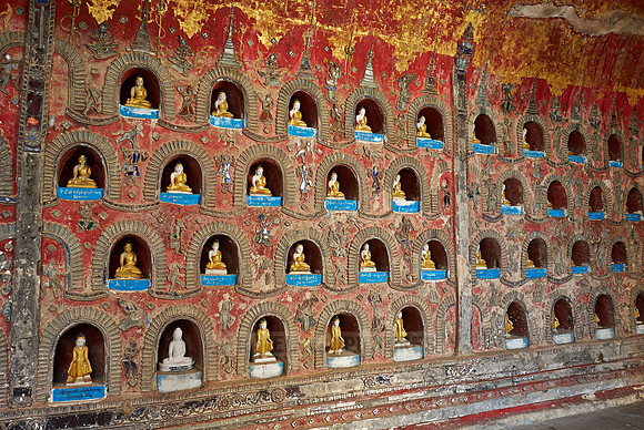 many small Budda figures in niches