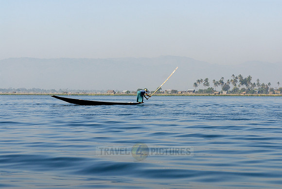 one leg rowing boat with fisherman