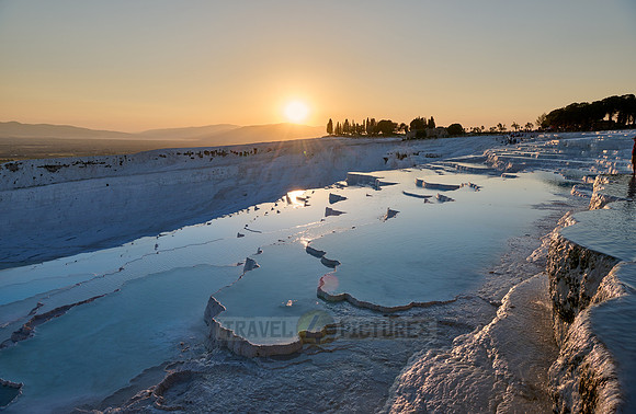 sunset behind Pamukkale travertine terraces