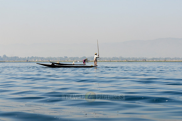 one leg rowing boat with fisherman