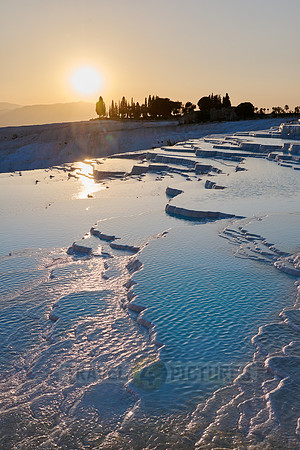 sunset behind Pamukkale travertine terraces