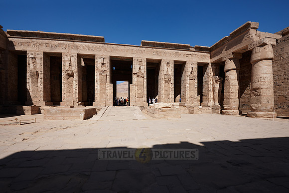 Columns of god Osiris at western colonade in second yard