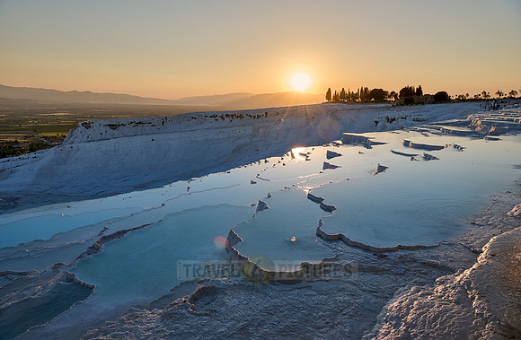 sunset behind Pamukkale travertine terraces