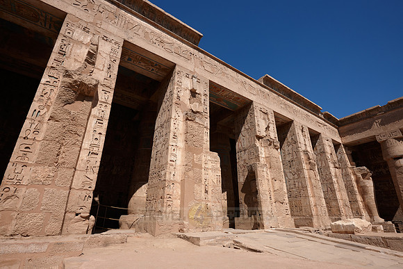 Columns of god Osiris at western colonade in second yard