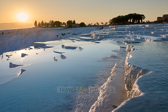 sunset behind Pamukkale travertine terraces