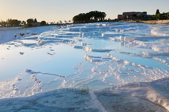 sunset behind Pamukkale travertine terraces