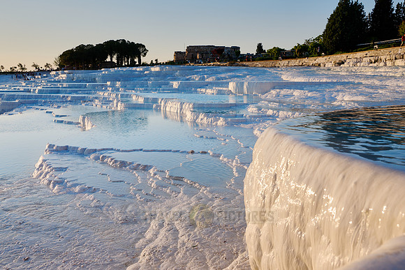 sunset behind Pamukkale travertine terraces