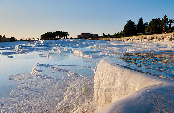 sunset behind Pamukkale travertine terraces