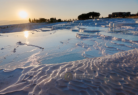 sunset behind Pamukkale travertine terraces